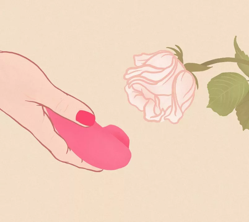 Na rysunku dłoń trzyma czerwony, bezdotykowy masażer łechtaczki skierowany w stronę białego kwiatu róży.