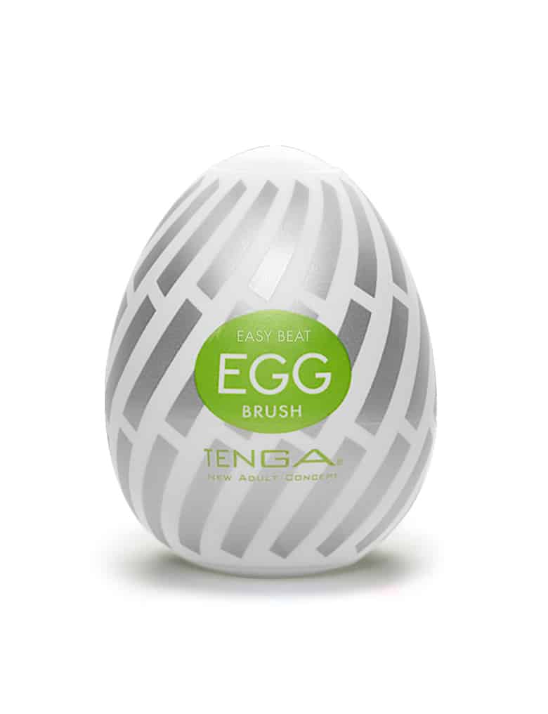 Masturbator Tenga Egg w kształcie jajka, z białą etykietą ze srebrnym wzorem skręconych paseczków i zielonymi elementami.